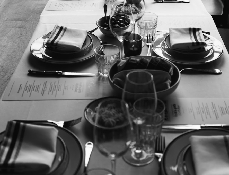 A private dinner table set for a seasonal plated menu